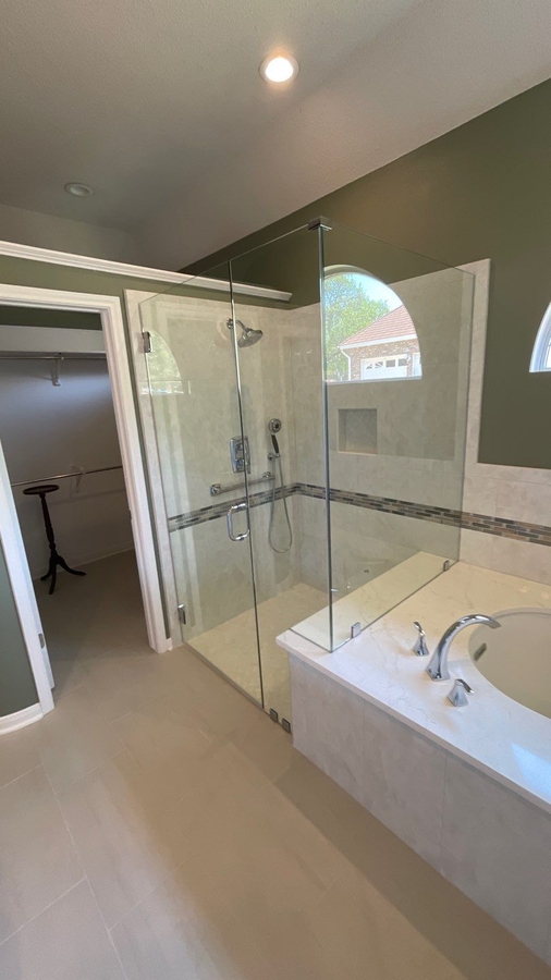 Bathroom remodel with green walls and white cabinetry in San Antonio by Wade