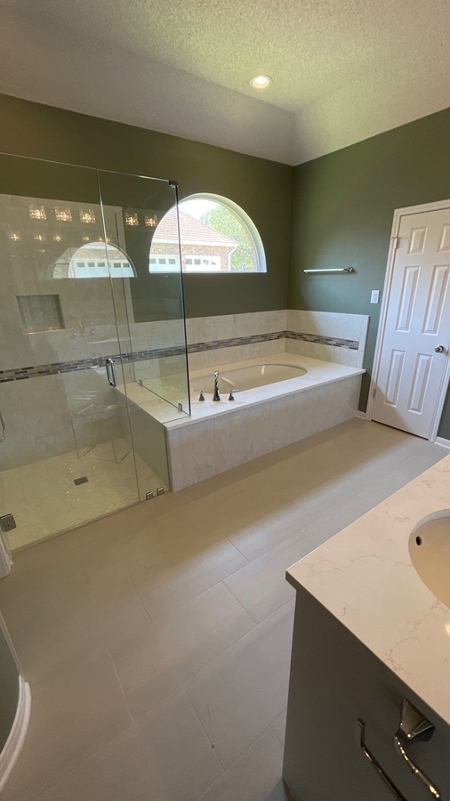 Glass-enclosed shower and tub combo bathroom remodel by Wade Caldwell Constr