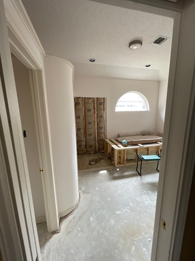 Renovation stage showing bath framing and exposed wall insulation by Wade C