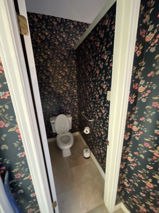 Toilet nook with floral wallpaper in San Antonio bathroom remodel by Wade C