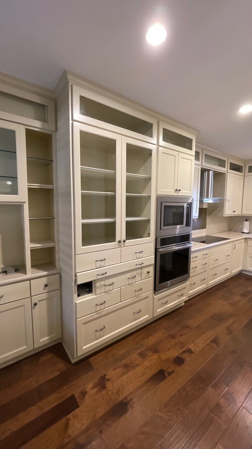 Tall cream-colored cabinets and double ovens in a San An