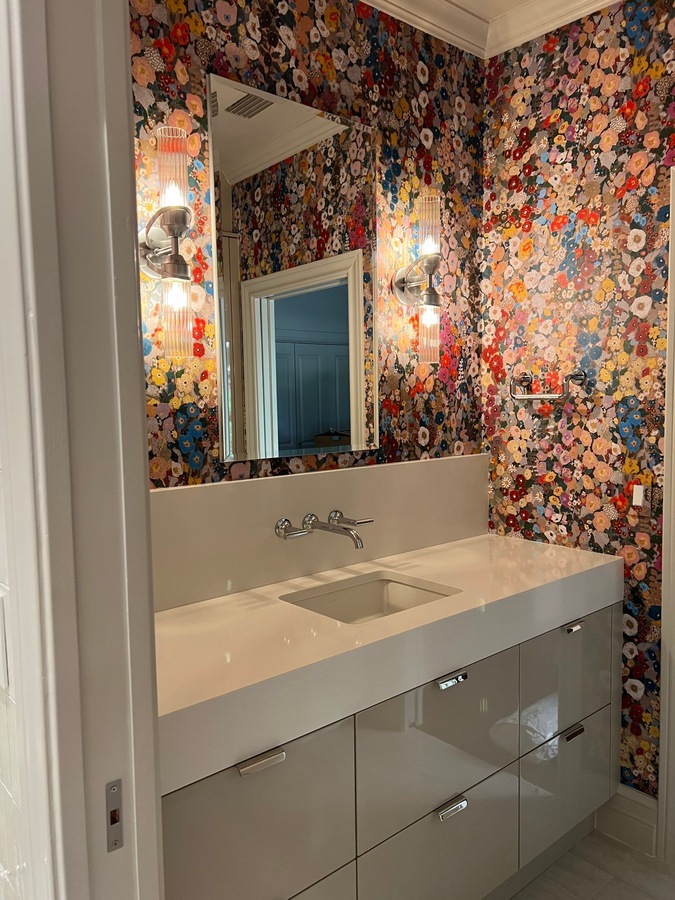 Bold floral wallpaper and floating vanity in San Antonio powder room remodel by Wade C
