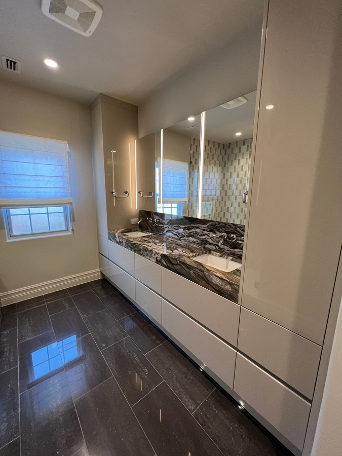 Modern double vanity and stone countertop in bathroom remodel by Wade Caldwell Constru
