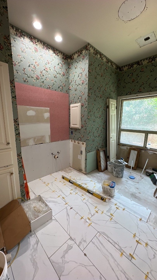 Alamo Heights bathroom mid-remodel with exposed drywall and tools by Wade Caldwell Constr