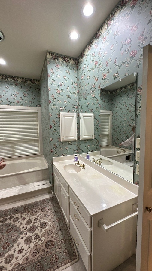Outdated floral wallpaper bathroom before remodel in Alamo Heights by Wade Caldwell Const