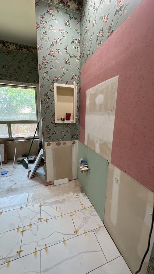 Remodeling progress photo featuring floor tile setting and wall prep by Wade Caldwell Con