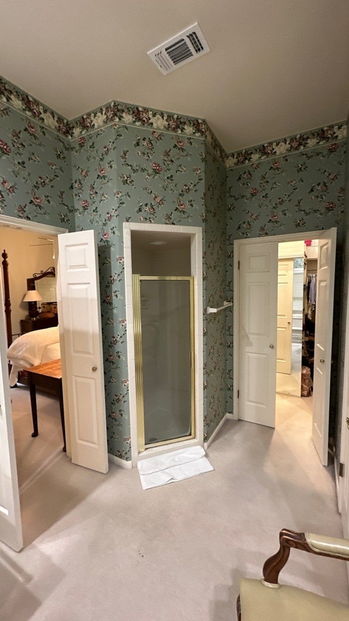 Shower stall with brass frame in original Alamo Heights bathroom by Wade Caldwell Constru