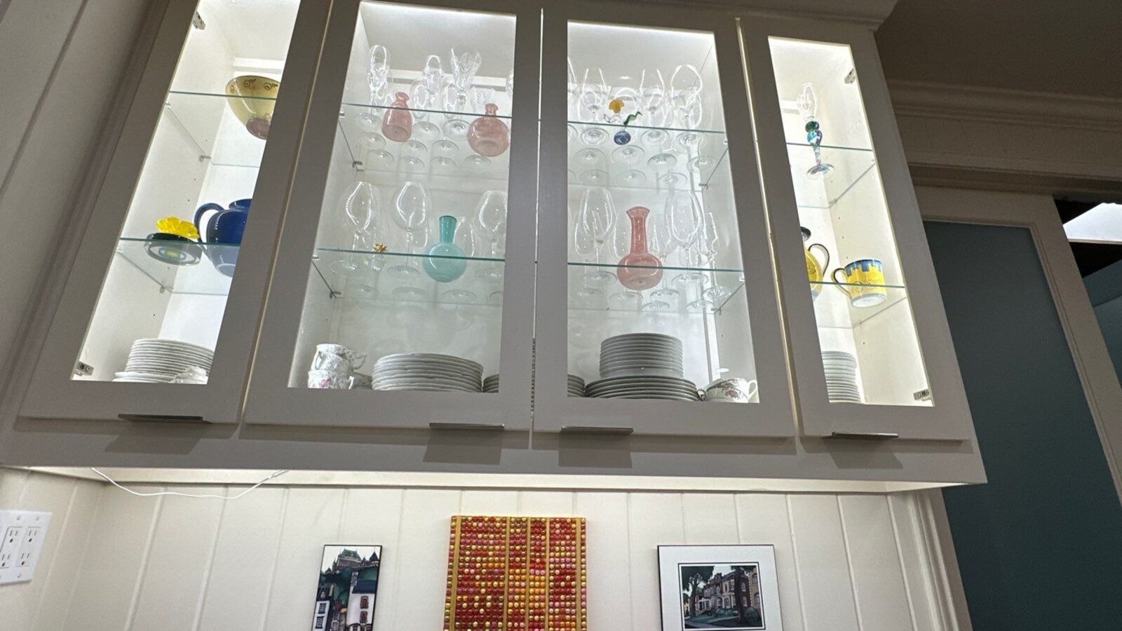 Detailed view of decorative cabinetry and dishware display in San Antonio kitchen by Wade Caldwell
