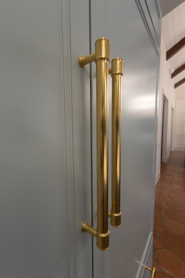 Brass refrigerator handles on custom cabinetry from kitchen remodel in Alamo Heights, TX by Wade C