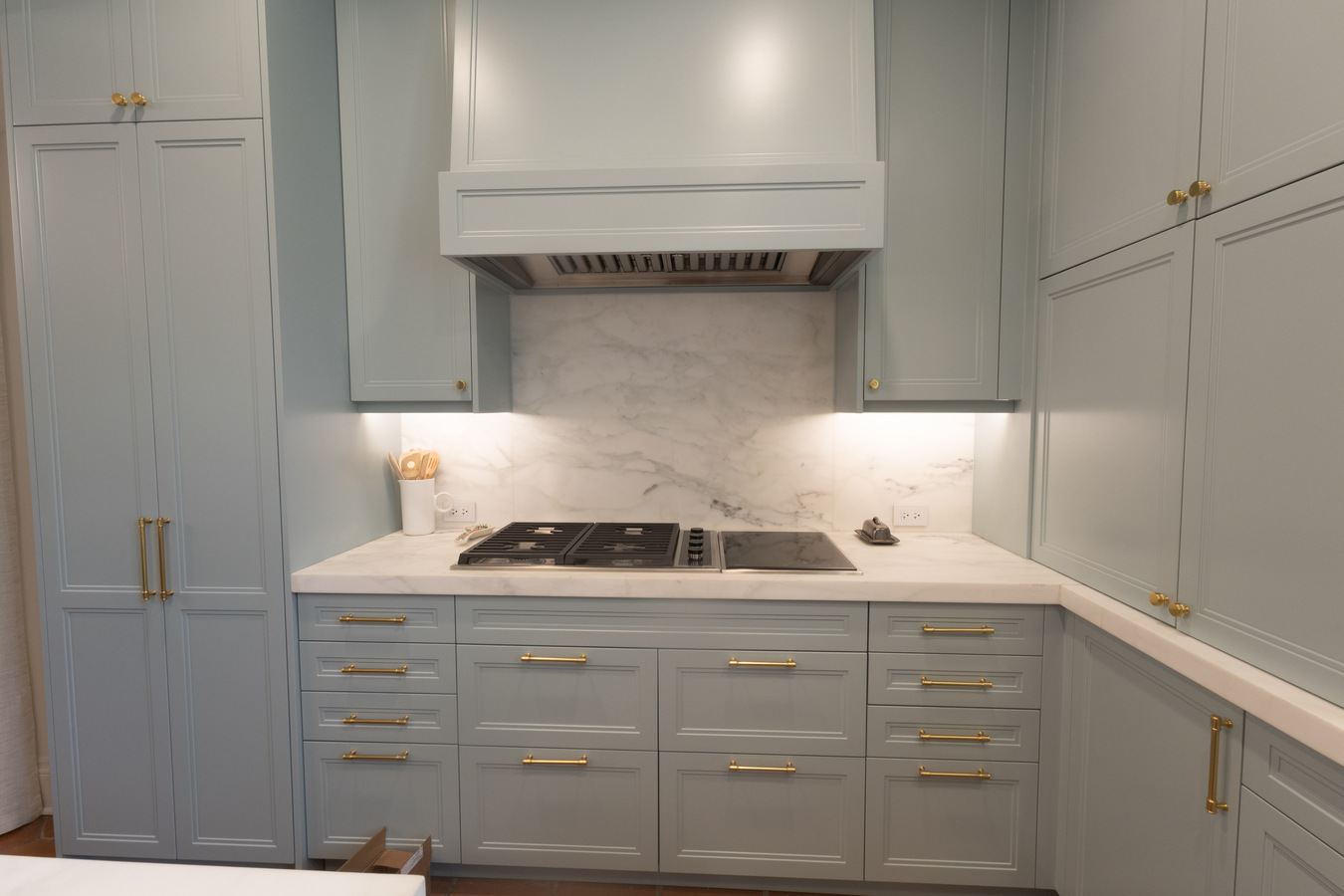 Close-up of kitchen stove and marble backsplash in custom remodel by Wade Caldwell Construction in