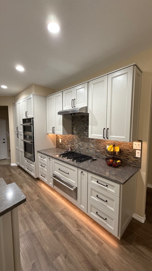 Sleek kitchen renovation featuring stainless appliances and under-cabinet li