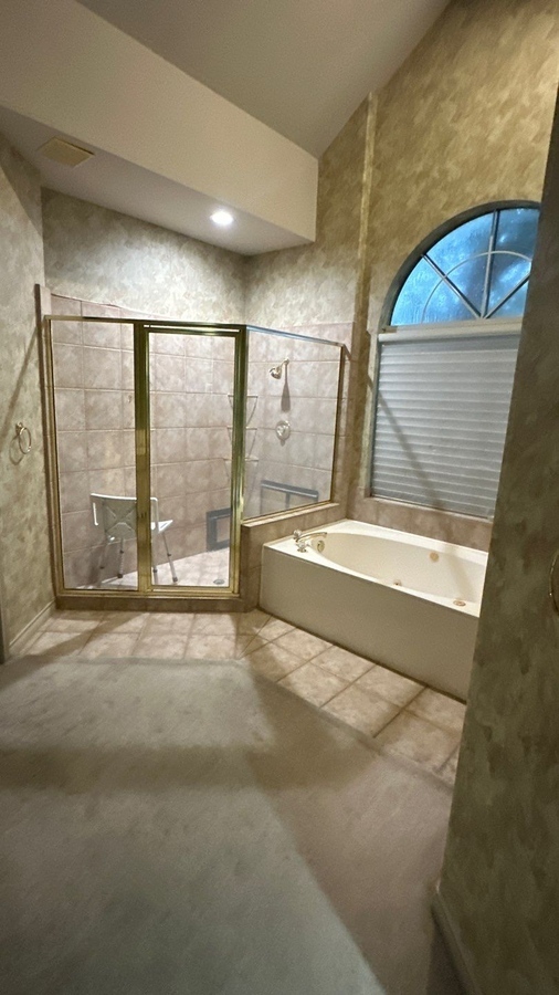 Outdated San Antonio bathroom with tile surround tub and framed glass showe