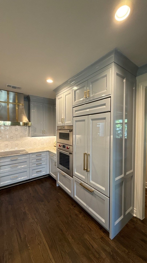 Built-in panel refrigerator and stacked ovens in high-end San Antonio kitchen remodel by Wade C