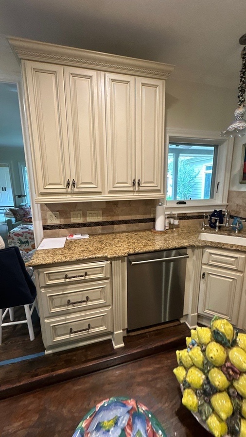 Corner kitchen design with classic cabinetry and granite counters remodeled by Wade Caldwell C