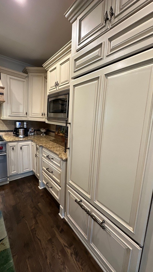 Panel-front refrigerator and matching cabinetry in San Antonio kitchen remodel by Wade Caldwel