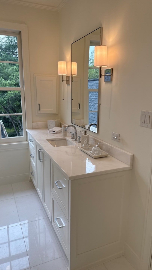 Double vanity bathroom remodel with large mirror and natural light in San Antonio by Wa