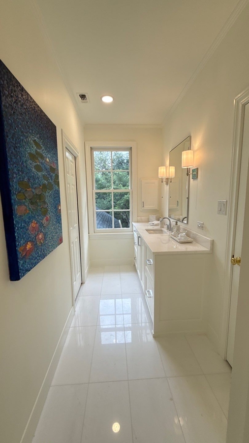 Long narrow bathroom remodel with updated vanity and accent artwork in San Antonio by W