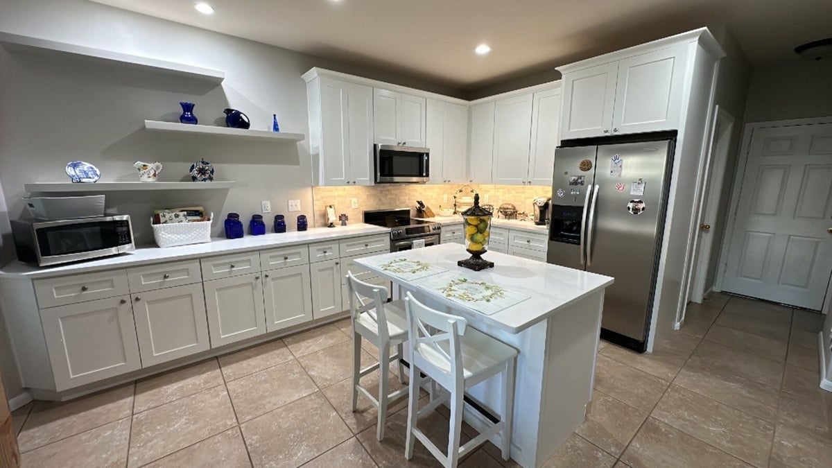 Bright white kitchen remodel with custom cabinetry and central island in San Antonio by Wade Caldwell