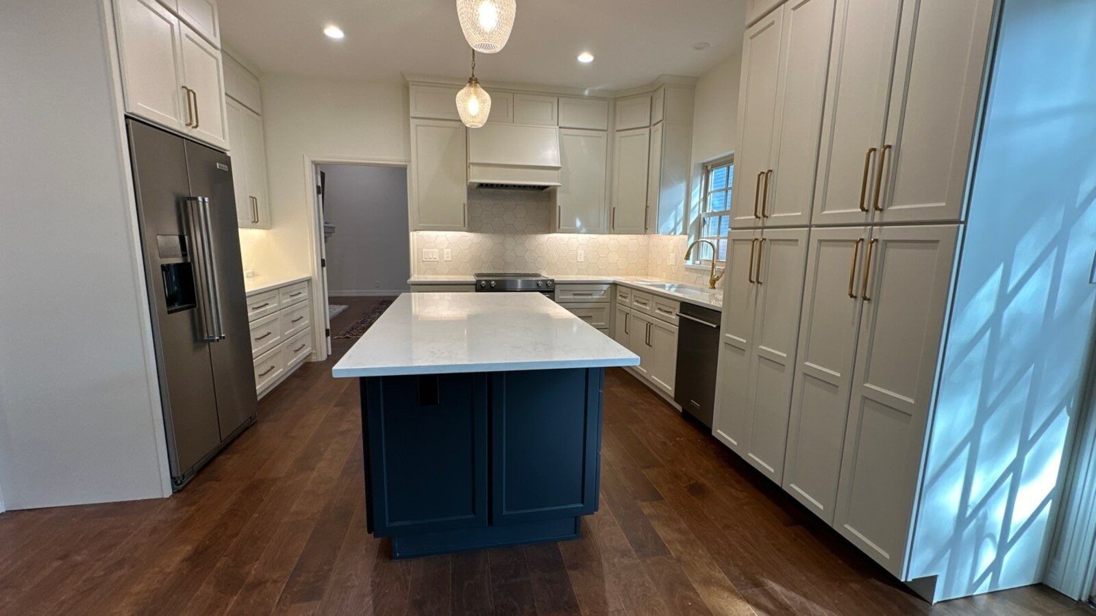 Full kitchen remodel with large center island and hexagon backsplash in Hill Country Village, T