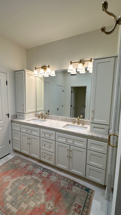 Remodeled bathroom with double vanity and warm lighting in Alamo Heights, TX by Wade Caldwell C