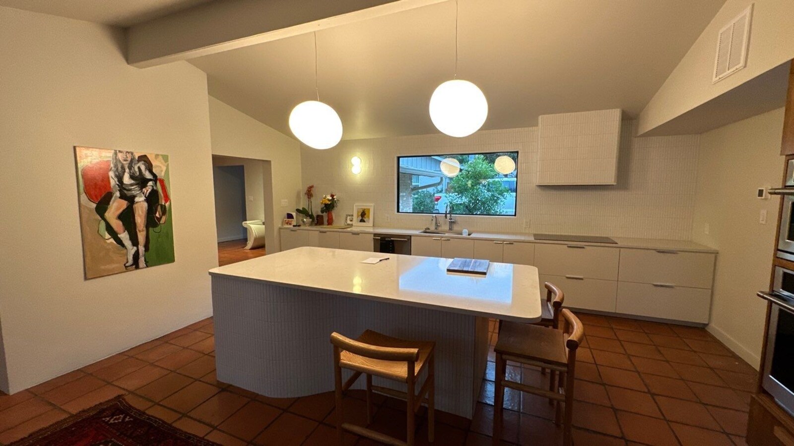 Renovated kitchen with center island and picture window in Shavano Park, TX by Wade Ca